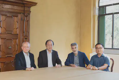 Convenors of IDAIS-Venice seated at a table